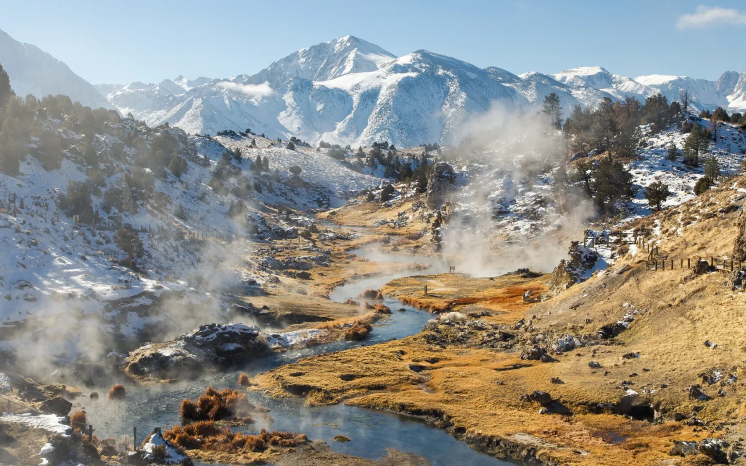 The Sierra Nevada mountains rise above the geothermal springs at Hot Creek, near Mammoth Lakes, California.